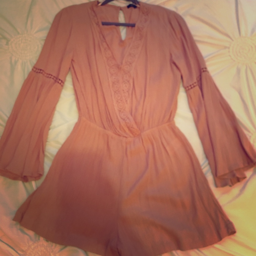 Dusty pink romper with lace detailing.